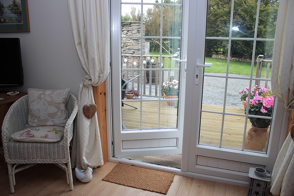 Garden Room has patio door out to a small wooden deck